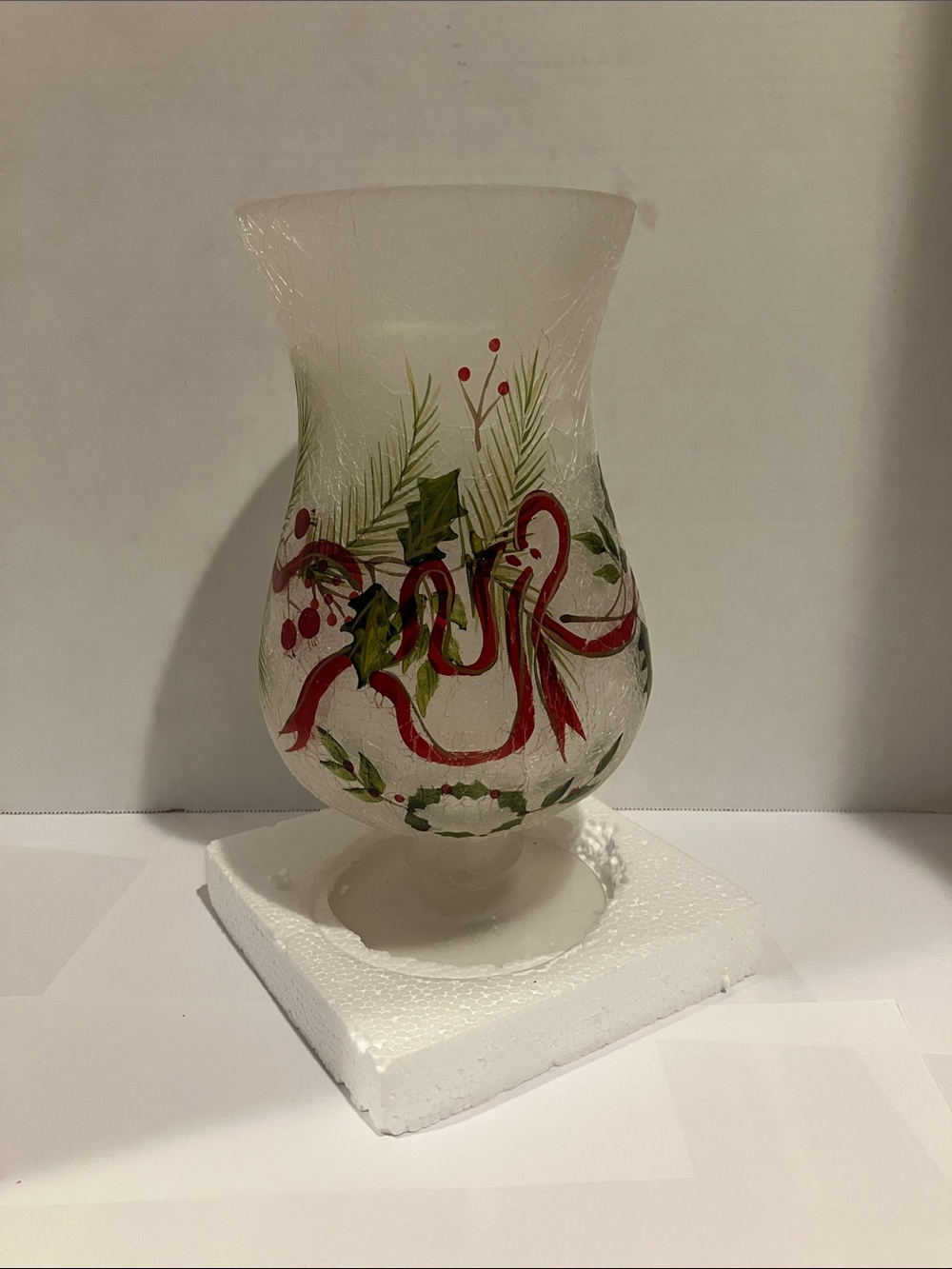 Home Essentials White Glass Holiday Hurricane with Red Ribbon and Green Foliage